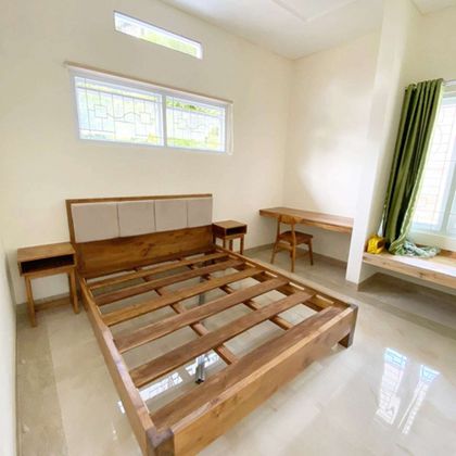 Teak bed frame in modern bedroom